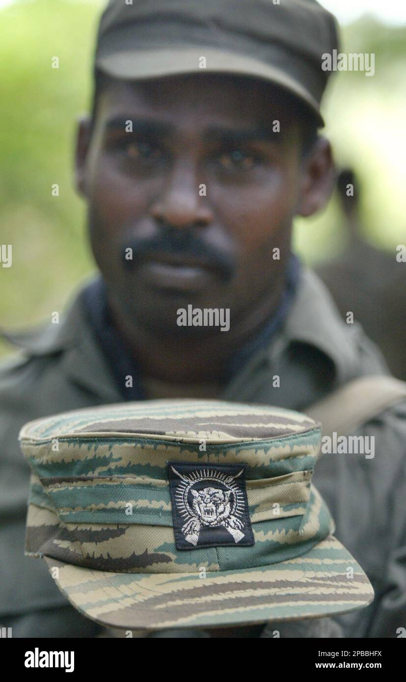 A Sri Lankan Army soldier shows a cap of a Tamil Tiger uniform in the ...